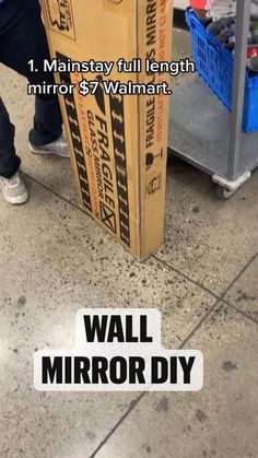 a cardboard box sitting on top of a floor next to a blue carton with the words wall mirror diy