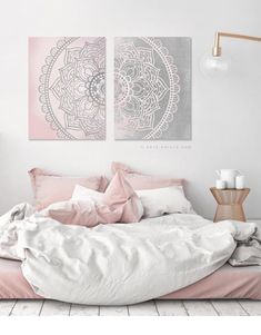 two paintings on the wall above a bed in a room with pink and grey decor