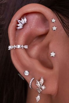 a woman wearing three different ear piercings