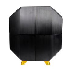 a black cabinet with yellow legs and an octagonal design on the front, against a white background