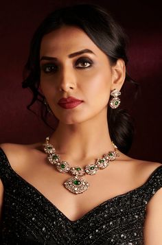 Inspired by the romantic Victorian era, this elegant necklace set is a true masterpiece. Encrusted with sparkling polki stones and adorned with cubic zirconia for added brilliance, it features emerald green stones that add a touch of color and allure. Accompanied by matching earrings, this set is the perfect choice for a formal occasion, exuding timeless charm and sophistication. Finish: Rhodium Plating Material: Silver, Copper Alloy, Emerald, Polki & CZs Color: Green Size: Free Size, Adjustable Elegant Hand Set Emerald Diamond Necklace, Elegant Hand-set Emerald Diamond Necklace, Elegant Green Diamond Necklace Hand Set, Elegant Green Hand Set Diamond Necklace, Green Diamond Temple Jewelry Necklace, Elegant Kundan Jeweled Necklaces, Exquisite Green Emerald Necklace With Diamond Accents, Elegant Green Diamond Necklace With Jewels, Elegant Green Diamond Necklace