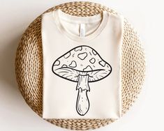 a white t - shirt with a mushroom on it