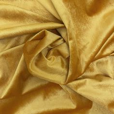 a close up view of a gold colored fabric that is very soft and shiny with some slight folds