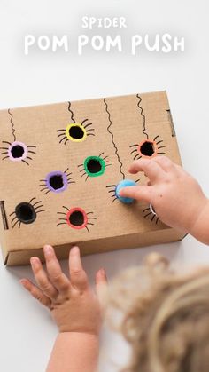 a child is playing with a cardboard box