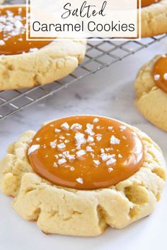 peanut butter cookies cooling on a wire rack with salt sprinkled on top and caramel sauce in the middle