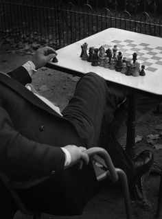 a man sitting at a table playing chess