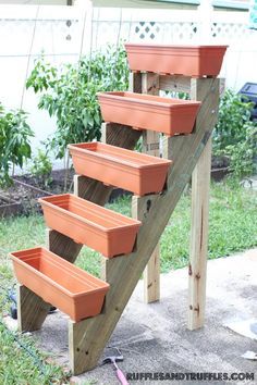 several planters are placed on the side of a wooden staircase