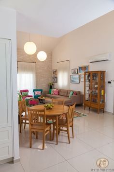 a living room filled with furniture and a dining table