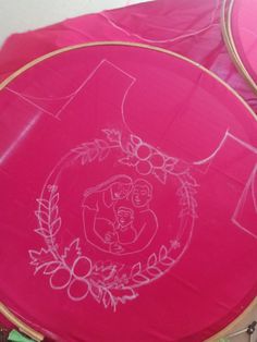 two pink frisbees sitting on top of a table covered in plastic wrap