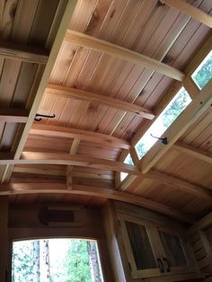 the inside of a building with wooden walls and ceiling beams on it's sides