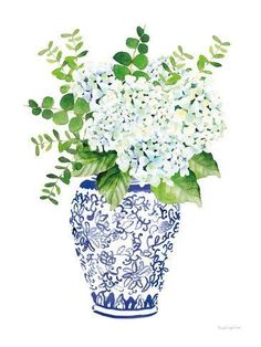 a blue and white vase with flowers in it