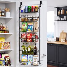 an organized pantry in a kitchen with lots of food and drinks on the shelves next to the door