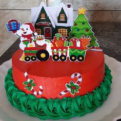 a cake decorated with christmas decorations on top of a table