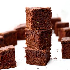 a stack of brownies sitting next to each other on top of a white table