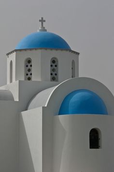 a white and blue building with a cross on top