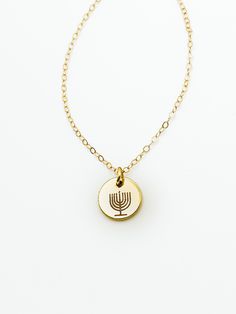 "Made in Portland, Oregon. I'll be honest I was always jealous of all the cute Christmas jewelry out there, so like any good entrepreneur I made my own Hanukkah line! Enjoy, share and have some fun this holiday season!  MEASUREMENTS + MATERIALS - Length comes in 16, 18 or 20 inches and is adjustable another 2 - Charm is about 10mm in diameter - Menorah stamp has 9 candles for Hanukkah  - Gold fill chain for sensitive skin (hypoallergenic) - Rose gold fill and silver fill are also available  WHAT Adjustable Gold Star Of David Jewelry, Nickel-free Star Of David Jewelry Gift, Star Of David Charms Jewelry For Gift, Hanukkah Pendant Jewelry, Hanukkah Gift Pendant Jewelry, Gold Star Of David Necklace Nickel Free, Gold Nickel-free Star Of David Necklace, Gold Star Of David Jewelry For Hanukkah, Star Of David Necklace For Hanukkah Gift