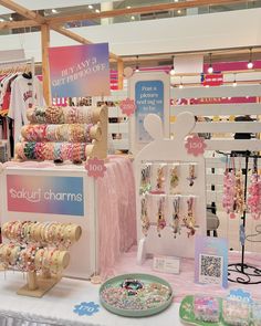 an assortment of bracelets and necklaces on display in a store with other items