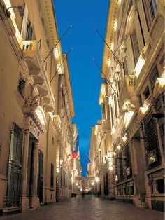 an empty street is lit up at night