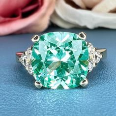 Smart Buys! Paraiba Green Tourmaline Cushion Cut Engagement Ring , 14k Gold Cushion Cut and Round Diamond Cluster Ring , Round Moissanite Accents #6525 starting from $740.00 See more. 🤓 #ParaibaTourmaline #PromiseRing #MothersDayGift #EngagementRing #DiamondRing #CushionCut #TourmalineRing #ParaibaRing #UniqueRing #ParaibaDiamond Luxury Green Cluster Ring With Rose Cut Diamonds, Luxury Cushion Cut Gemstone Wedding And Engagement Rings, Luxury Green Diamond Cluster Ring, Luxury Cushion Cut Emerald Jewelry, Luxury Cushion Cut Diamond Ring With Gemstone, Luxury Collectible Cluster Ring With Center Stone, Luxury Green Cubic Zirconia Cluster Ring, Luxury Tourmaline Round Cut Ring, Luxury Classic Cushion Cut Gemstones