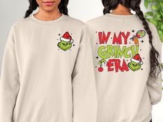 "In My Grinch Era Sweatshirt, Grinch Christmas Sweatshirt, Grinchmas Sweater For Girl, Christmas Movie, Christmas Gift, Christmas Sweatshirt 🌾Welcome to \"Boutique Grace Sweatshirt & Hoodie store\"... I will be presenting sweatshirts and hoodies, which are indispensable for your autumn and winter days, with special and different designs in my store.🌾 🌾Product Features ✔️Gildan® Heavy Blend™ Unisex Sweatshirt  ✔️50% Cotton / 50% Polyester ✔️Preshrunk fleece knit ✔️Classic Fit ✔️ Air jet yarns Grinch Christmas Sweatshirt, Grinch Sweater, Movie Christmas, Christmas Jacket, Funny Xmas Gifts, Hoodie Store, Cute Shirt Designs, Girl Christmas, Matching Tees