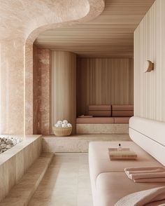 a spa room with white and beige walls, large bathtubs and towels on the floor