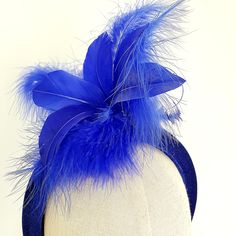 Little Hats for Grand Occasions. Customer information and sizing. Royal blue,cobalt blue feathers and hand curled quills on a velvet padded headband, fascinator, halo.  Perfect statement headband for weddings, special events, racing or a grand occasion. Embellishments, feathers, buttons and brooches are lovingly sourced for unique individual pieces. Headband measures 4cm at it's top widest point and sits cormfortably on the head. Handmade in the UK. No two designs are the same. Please message me to discuss any personnal requirements. Return and exchanges except within 14 days. Please read the full details in the FAQS. Many more designs on the shop. Blue Feather Trim Headpiece For Wedding, Blue Feather Trim Fascinator For Kentucky Derby, Blue Feathered Headpiece For Party, Blue Feathered Wedding Fascinator, Blue Feathered Wedding Costume Hat, Blue Wedding Costume Hat With Feathers, Blue Wedding Headpiece With Feather Trim, Blue Feathered Fascinator For Races, Blue Feather Fascinator For Races