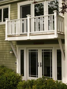 a house with white balconies and windows