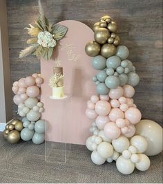 balloons are arranged in the shape of an eiffel tower with a cake on top