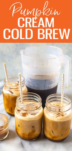 pumpkin cream cold brew in mason jars with two straws on the top and three glasses full