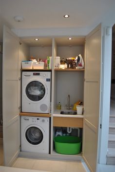 there is a washer and dryer in this small room with the door open