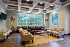 a living room filled with furniture and lots of windows