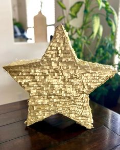 a decorative gold star sitting on top of a wooden table