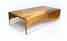 a wooden table with metal legs and a wood slab on the top that is shaped like a wave