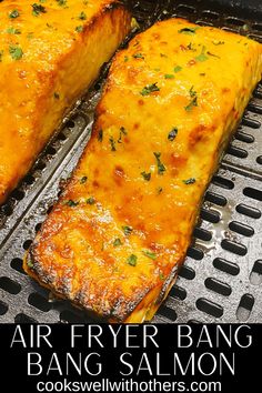 two pieces of food cooking on top of a grill with the words air fryer bake salmon