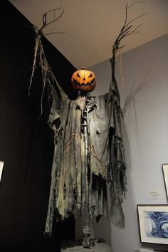 a bathroom decorated for halloween with decorations on the wall and ghost hanging from the ceiling