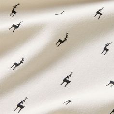 a white fabric with black deer silhouettes on it