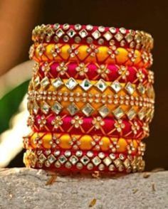 Bangles is an Indian artistic handcraft brand set out to create mesmerizing designs that people would desire to keep and treasure. Every woman is a balance of Beauty, Power & Elegance and we at Bangles aspire to compliment & showcase this Balance. Indian Beauty resides in vibrant colors and soothing elegance, two things that traditionally don't mix together. Elegance demands tranquility while Vibrancy demands energy. Bride And Groom Name Bangles Handmade Bangle For Celebrations, Multicolor Handwork Bangle As Gift, Handwork Multicolor Bangle Jewelry, Handmade Pink Bracelets For Diwali, Pink Handmade Bracelet For Diwali, Multicolor Handwork Jewelry For Diwali, Handmade Pink Bracelet For Diwali, Handmade Bangle For Marriage And Festivals, Festive Multicolor Handwork Bangle