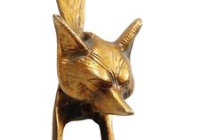 a gold colored cat figurine with its eyes closed