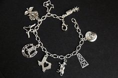 A collection of silver plated Texas themed charms have been dispersed around a shimmering silver plated bracelet chain in this handmade charm bracelet. This Texas charm bracelet is then completed with a lobster clasp and a 1/2 inch of chain at the end for adjustable sizing. Charms in this bracelet include two Texas state charms, a lone-star charm, an oil rig charm, bull charm, Texas rose charm, boot spurs charm, horseshoe with cowboy boots charm, and a long horn charm. ● Sizing ● To determine yo Symbolic Silver Bracelets With Dangling Charms, Silver Symbolic Bracelets With Dangling Charms, Symbolic Silver Bracelet With Dangling Charms, Symbolic Sterling Silver Charm Bracelet, Silver Metal Chain Bracelet With Dangling Charms, Personalized Symbolic Silver Bracelets, Symbolic Silver Bracelets With Charms, Silver Adjustable Chain Bracelet With Dangling Charms, Adjustable Silver Chain Bracelet With Dangling Charms