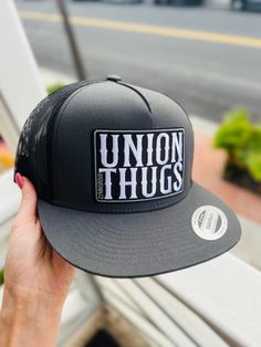 Union Thugs HAT DESCRIPTION: ORIGINAL - YP Classic snapback - 80/20 acrylic/wool - Structured, six-panel, high-profile - Flat bill with GREEN undervisor - Snapback closure NET BACK -Classic Trucker hat * Classic trucker cap with premium mesh panels * Hard buckram. Structured * Matching plastic snapback closure -------------------------- HARD MEASUREMENTS:  Crown Height   -   3 3/4" Hat size   -    6 5/8-7 3/8 -------------------------- COLORS: -Black - Regular & Net -Camo - Regular  -Camo Black net & Green net -Black Camo -Navy Blue -Charcoal/Black -Mesh -Red - Black Mesh ------------------------ ISSUES? DM me & ill do my best to fix the problem! Urban Trucker Hat With Flat Bill, Snapback Hats With Logo Patch, Streetwear Snapback Fitted Hat With Logo Patch, One Size Logo Patch Hats For Streetwear, Trucker Hat With Curved Brim For Streetwear, Trucker Cap With Logo Patch, Urban Snapback Baseball Cap With Logo Patch, Trucker Snapback Hat With Flat Brim For Streetwear, Urban Cap With Logo Patch