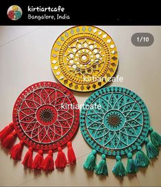 three different colored plates with tassels on them