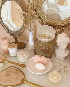 there is a mirror and other decorative items on the table in front of this vanity