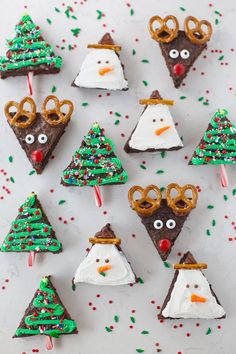 christmas treats are arranged in the shape of snowmen and reindeers with pretzels on them