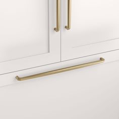 a white cabinet with brass handles on it