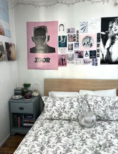 a bed in a bedroom with pictures on the wall