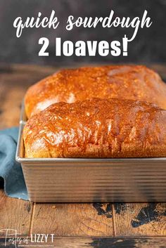 a loaf of quick sourdough 2 loaves in a pan on a wooden table