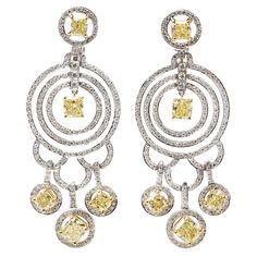 These Statement Earrings by Graff Diamonds feature 10 fancy yellow Diamonds of 8.00ct total and white Diamonds of approximately 2.00ct total, made in 18k White Gold. The two central yellow diamonds are laser inscribed and correspond with GIA reports stating 1.15ct, fancy yellow colour, VVS2 clarity and 1.15ct, fancy light yellow colour, VS1 clarity. These Earrings have secure omega backs. Complete with Graff Diamonds Box. Graff Cushion Cut Yellow Diamond 18ct White Gold Chandelier Earrings Brand Luxury Yellow Jewelry With Brilliant Cut, Graff Yellow Diamond Earrings, Elegant Yellow Diamond Cut Earrings, Luxury Yellow Diamond Earrings, Luxury Yellow Gold Sterling Silver Chandelier Earrings, Luxury Yellow Diamond Cut Earrings, Graff Jewelry, Graff Diamonds, Diamond Chandelier