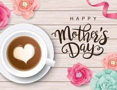 a cup of coffee and pink flowers on a wooden table with the words happy mother's day