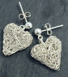 Hand knitted sterling silver wire earrings. They hang from a sterling silver round ball stud. The hearts measure 12mm x 15mm. Handmade Silver Heart Pendant Earrings, Silver Wire Earrings, Sterling Silver Heart Earrings, Silver Heart Earrings, Wire Earrings, Sterling Silver Heart, Heart Earrings, Silver Wire, Silver Heart