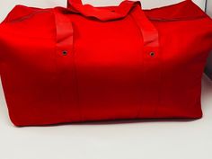 This is a big size red duffel bag, made out of thick canvas that can be used for multi-purposes. The product dimensions are: Height: 10 inches; Width: 20 inches; Depth: 9 inches. Christmas Aprons, Red Quilts, Duffel Bags, Travel Duffel, Duffel Bag Travel, Light Jacket, Quilted Jacket, Duffel Bag, Big Size